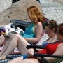 Scene from Last Summer at Blue Fish Cove. Three beautiful women sunbathing and reading on beach.